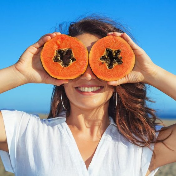 summer nutrition woman with papaya summer nutrition tips